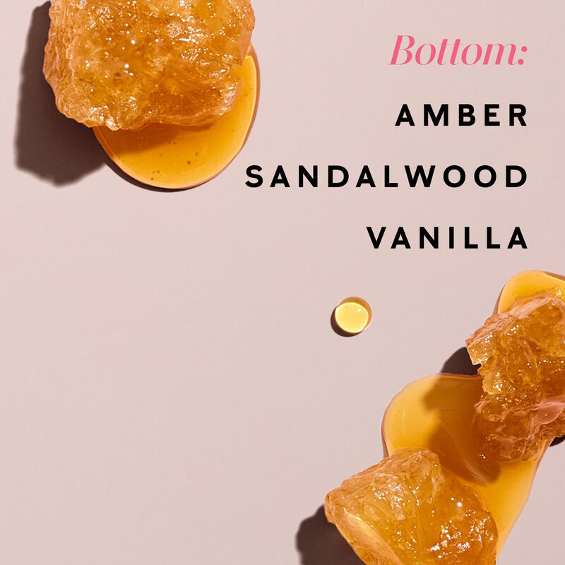 Drops of amber appear on a light pink background.
