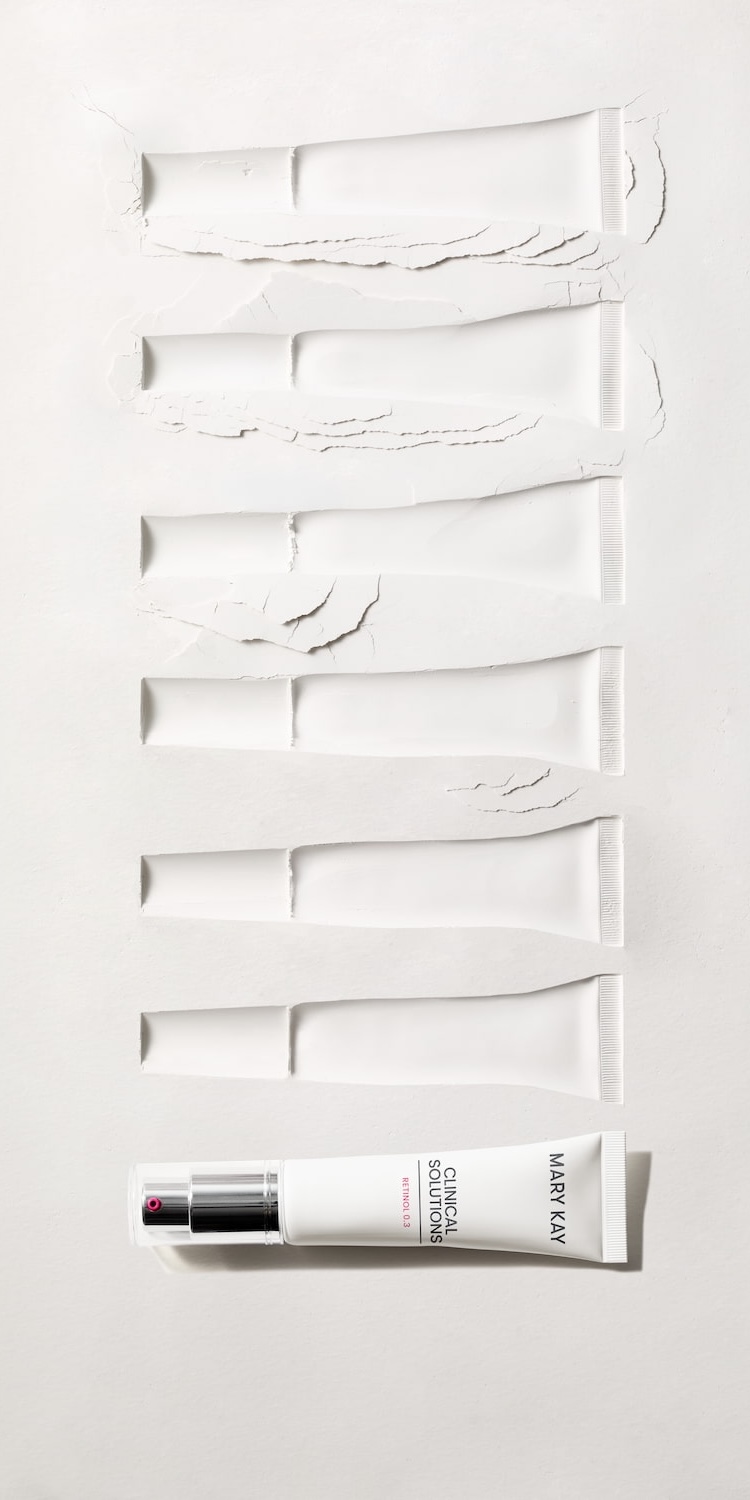 Tubes of Mary Kay Clinical Solutions imprinted in sand